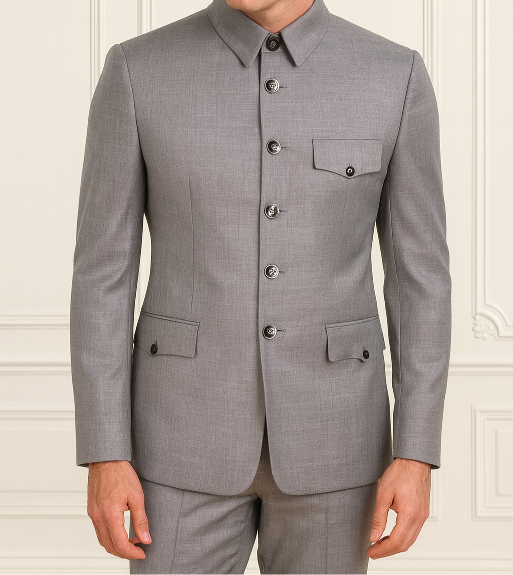 Man wearing a gray suit against a white wall