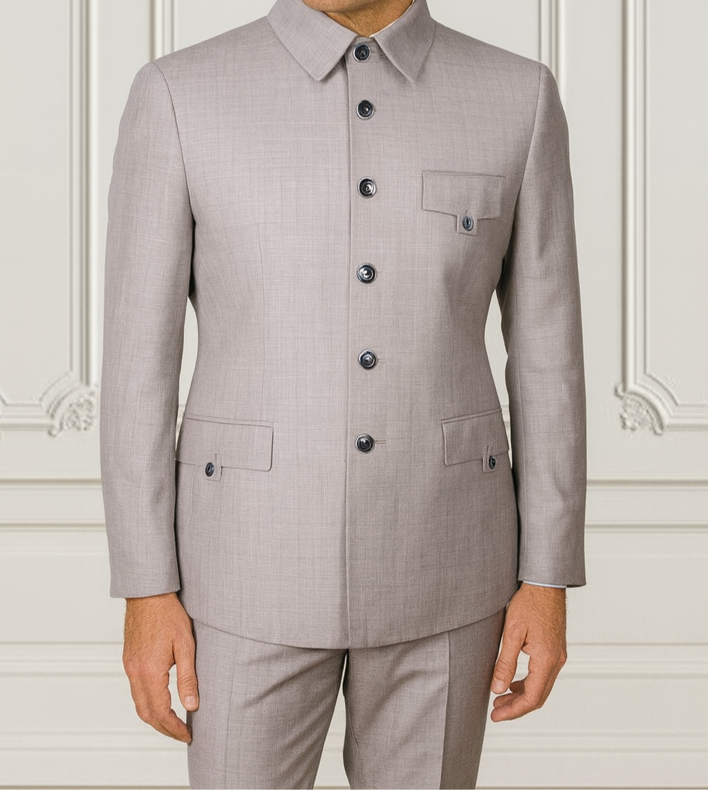 Man wearing a gray suit with a white wall background