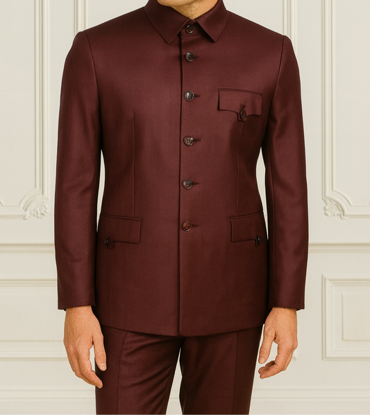 Man wearing a burgundy suit against a white wall