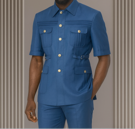 Man wearing a blue outfit with gold buttons against a neutral background
