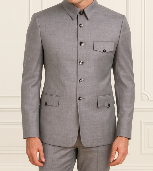 Man wearing a gray suit against a white wall