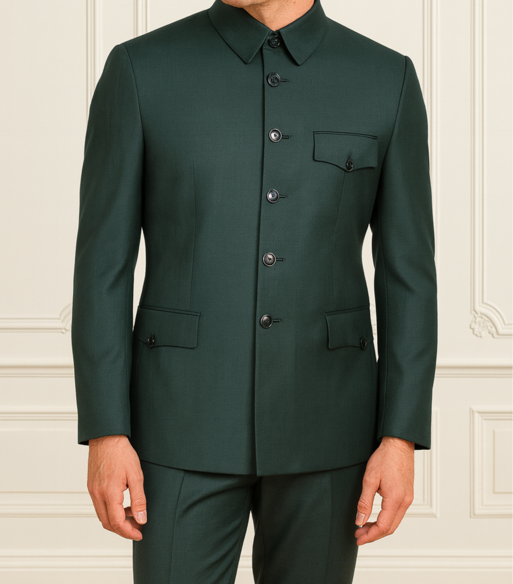 Man wearing a dark green suit against a white wall