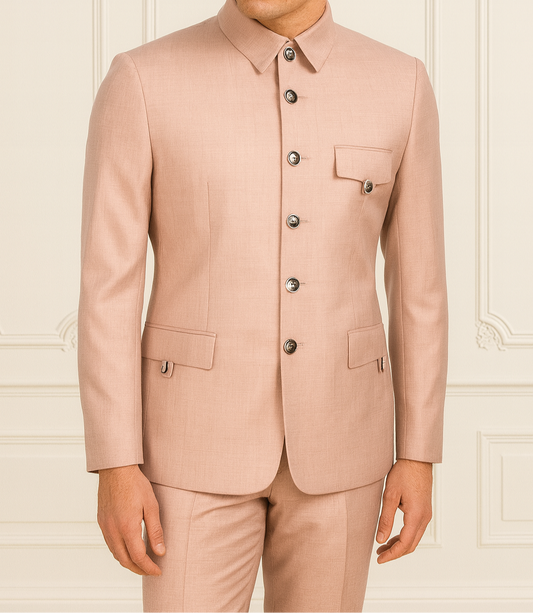 Man wearing a light pink suit against a neutral background