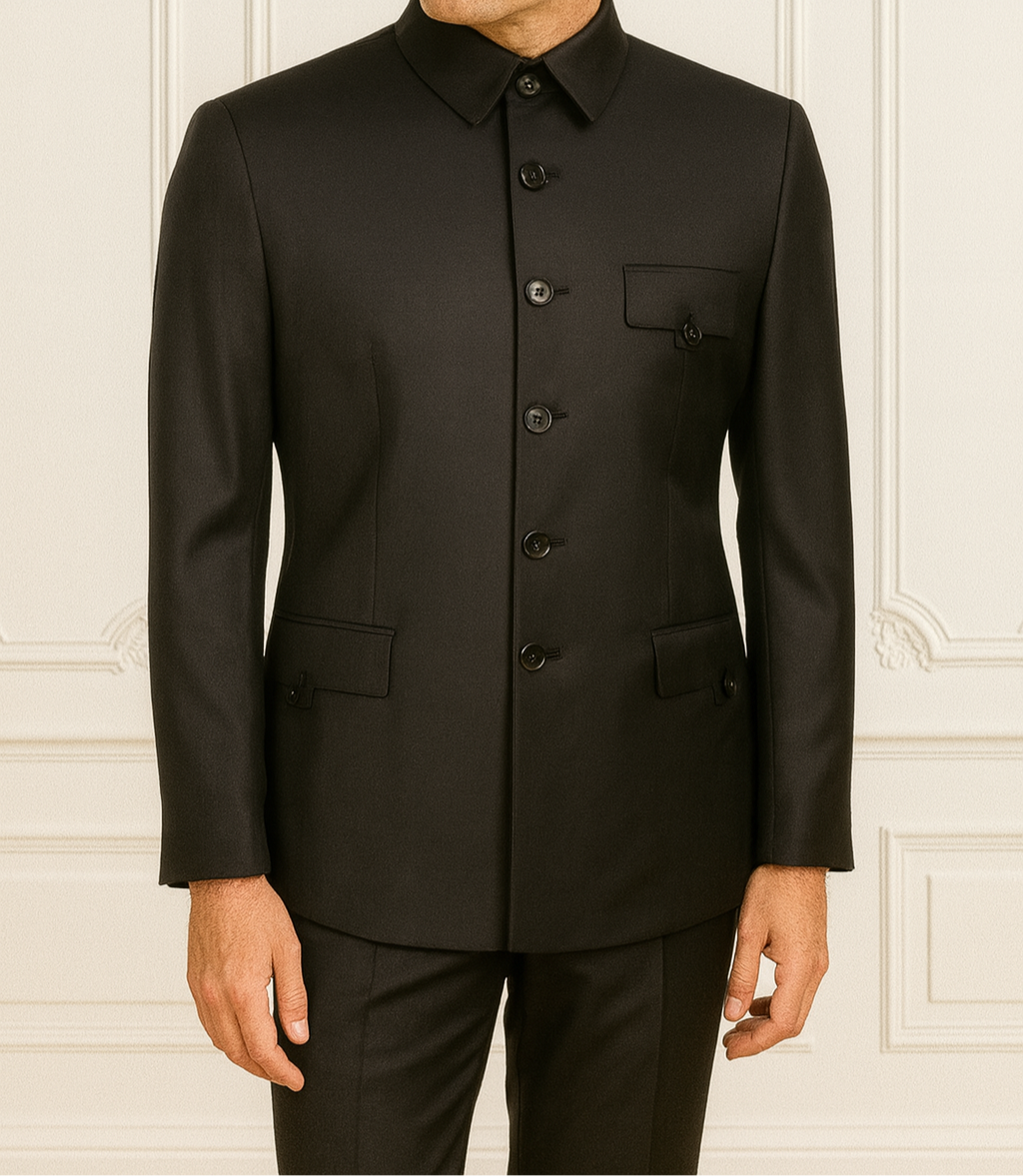 Man wearing a black suit against a white wall