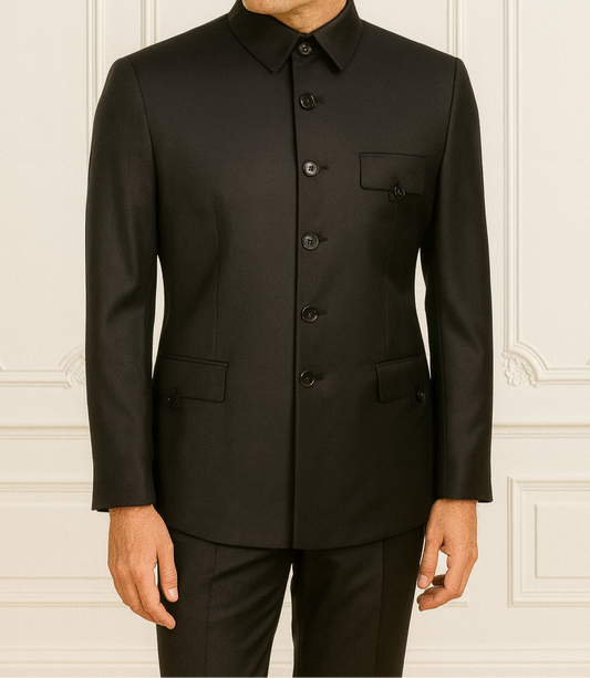 Man wearing a black suit against a white wall